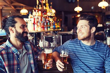 Image showing happy male friends drinking beer at bar or pub