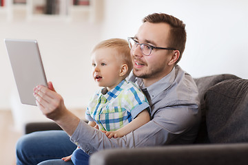 Image showing father and son with tablet pc playing at home