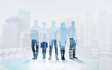 Image showing business people silhouettes over city background