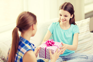 Image showing happy little girls with birthday present at home