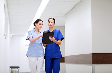 Image showing two medics or nurses at hospital with clipboard