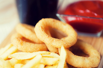 Image showing close up of fast food snacks and drink on table