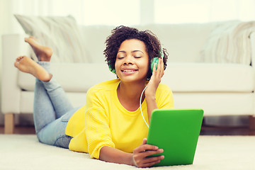 Image showing happy african woman with tablet pc and headphones