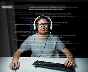 Image showing man in headset hacking computer or programming