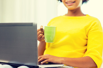 Image showing happy african american woman with laptop at home