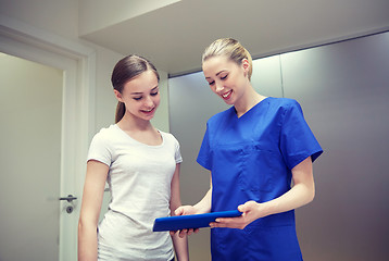 Image showing smiling nurse with tablet pc and girl at hospital