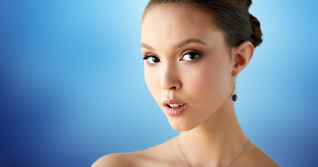 Image showing close up of beautiful woman face with earring