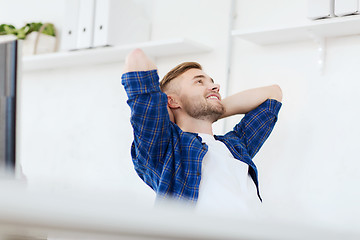 Image showing happy creative man with computer at office