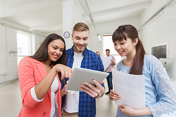 Image showing creative team with tablet pc and papers at office