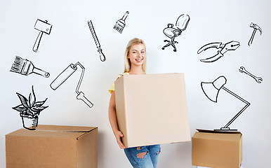 Image showing smiling young woman with cardboard box at home