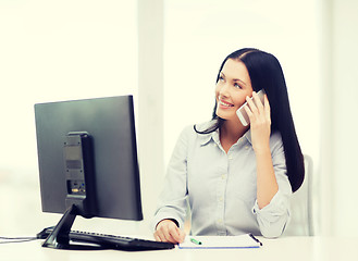 Image showing smiling businesswoman or student with smartphone