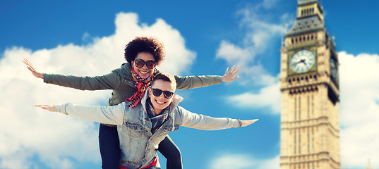 Image showing happy teenage couple having fun over big ben tower