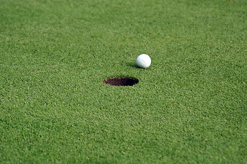 Image showing Golfball in front of the hole