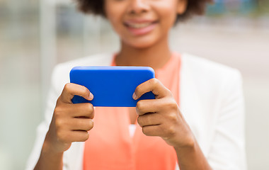 Image showing close up of african woman with smartphone in city