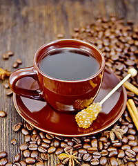 Image showing Coffee in brown cup with sugar and star anise on board