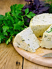 Image showing Cheese homemade round with herbs on board