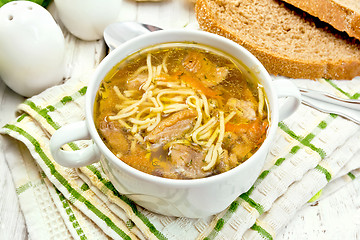 Image showing Soup with mushrooms and noodles in bowl on napkin