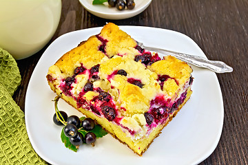 Image showing Pie with black currant in plate and fork on board