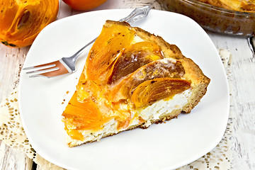 Image showing Pie with curd and persimmons with fork in plate on board