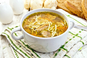 Image showing Soup with mushrooms and noodles in bowl on board