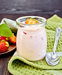 Image showing Yogurt with strawberries in jar on napkin