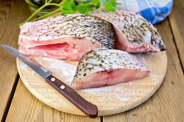Image showing Bream raw pieces on old board