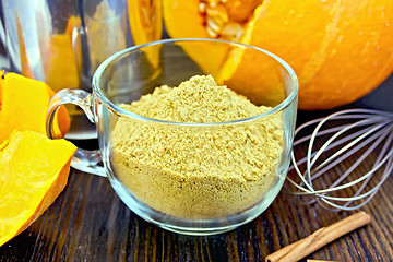 Image showing Flour pumpkin in glass cup with sieve and a mixer on board