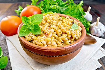 Image showing Barley porridge with basil on board