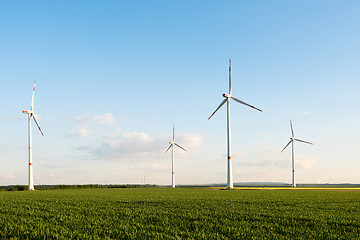 Image showing Wind turbines in front of a coal-fired plant