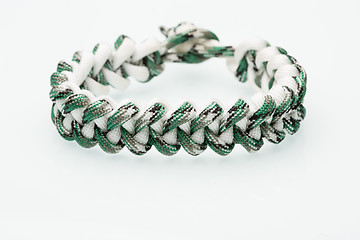 Image showing green braided bracelet on white background