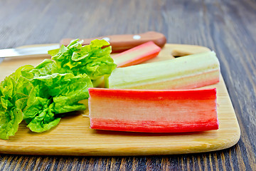 Image showing Rhubarb with knife on dark board