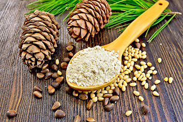 Image showing Flour cedar in spoon and nuts on board