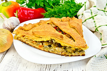 Image showing Pie with cabbage and sorrel in plate on light board