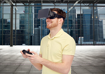 Image showing happy man in virtual reality headset with gamepad