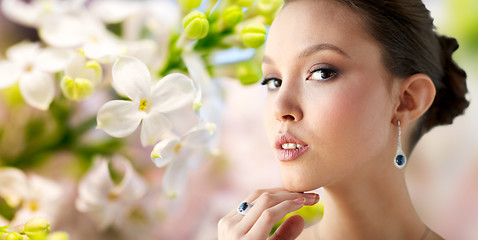 Image showing beautiful woman with earring and finger ring