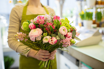 Image showing close up of woman holding bunch at flower shop