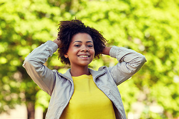 Image showing happy african american young woman in summer park