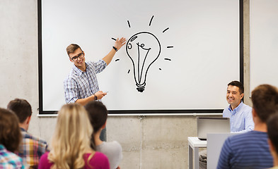 Image showing group of students and teacher at white board