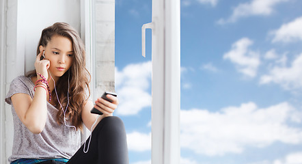 Image showing teenage girl with smartphone and earphones