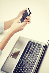 Image showing close up of woman texting on smartphone at office