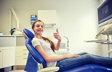 Image showing happy patient girl showing thumbs up at clinic