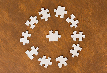 Image showing close up of puzzle pieces on wooden surface