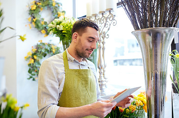 Image showing man with tablet pc computer at flower shop