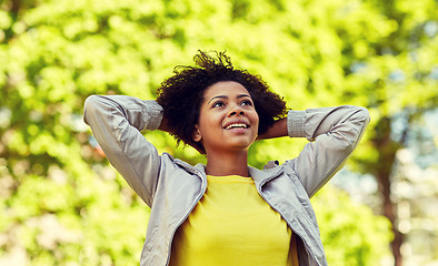 Image showing happy african american young woman in summer park