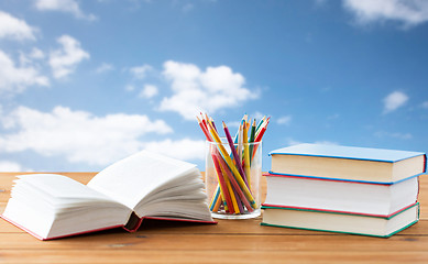 Image showing close up of crayons or color pencils and books