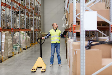 Image showing man with loader and clipboard at warehouse