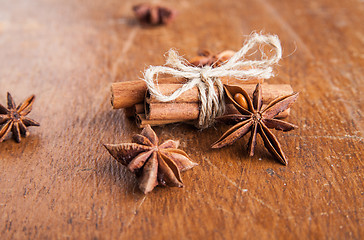 Image showing Cinnamon sticks and star anise on rustic wood