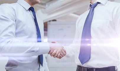 Image showing two businessmen shaking hands in office