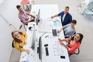 Image showing creative team with computers, blueprint at office