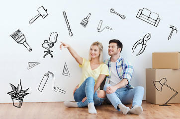 Image showing couple with boxes moving to new home and dreaming